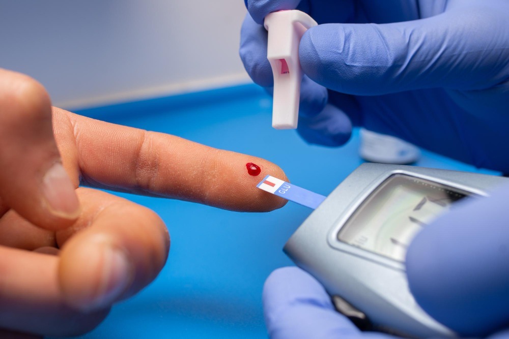 Close-up of a finger prick blood glucose test